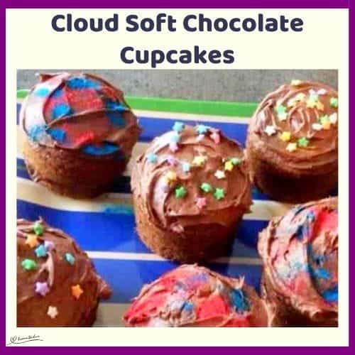 An image of 6 x-large Cloud Soft Chocolate Cupcakes with chocolate frosting and colored sprinkles