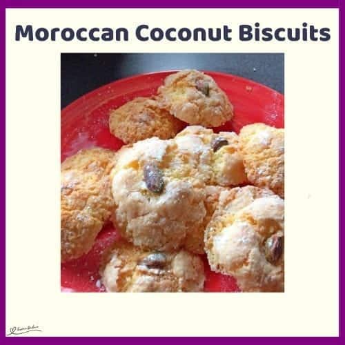 An image of Moroccan Coconut Biscuits with Sugar Dust on a red plate