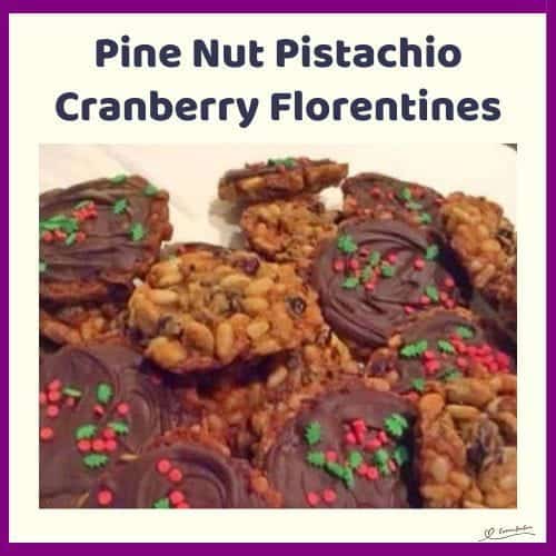 An image of a stack of Pine Nut Pistachio Cranberry Florentines with chocolate bottoms and fancy Christmas Sprinkles