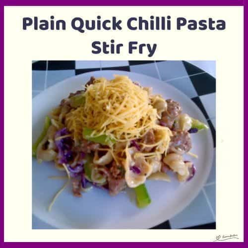 An image of a plate filled with a Chilli Pasta Stir Fry topped with grated cheese