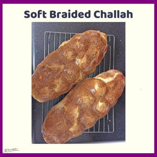 An image of 2 Soft Braided Challah on a cooling wire rack