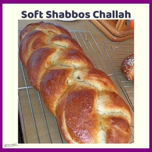 An image of 2 Braided Shabbos Challahs on a cooling rack