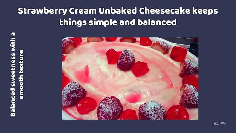 An image of a bowl filled with a Strawberry Cream Unbaked Cheesecake and decorated with strawberry jellie and fresh strawberries