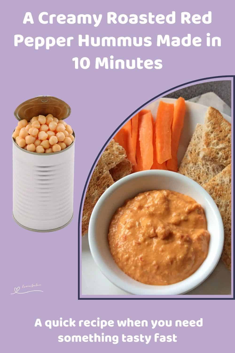 An image of a white bowl filled with Creamy Roasted Red Pepper Hummus with toasted bread triangles and carrots on the side
