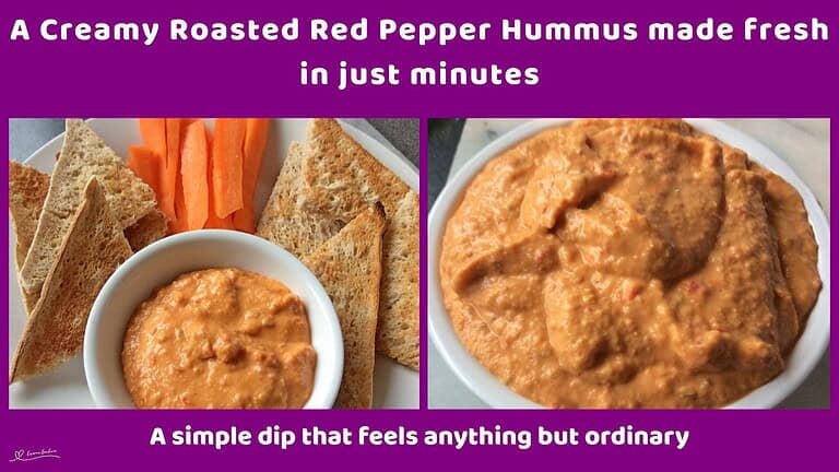 An image of a white bowl filled with Creamy Roasted Red Pepper Hummus with toasted bread triangles and carrots on the side