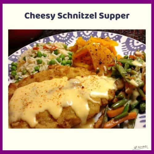 An image of Cheesy Schnitzel Supper with a Rich Cheese Sauce and Veggies on the side