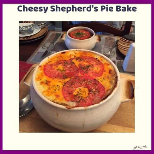 An image of a round white bowl filled with Cheesy Shepherd's Pie Bake