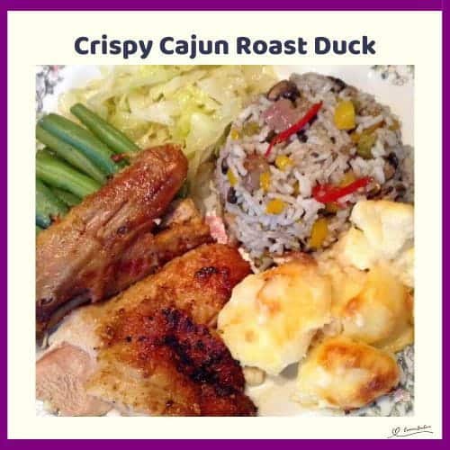 An image of Crispy Cajun Roast Duck with roasted potatoes, green beans and rice on the side