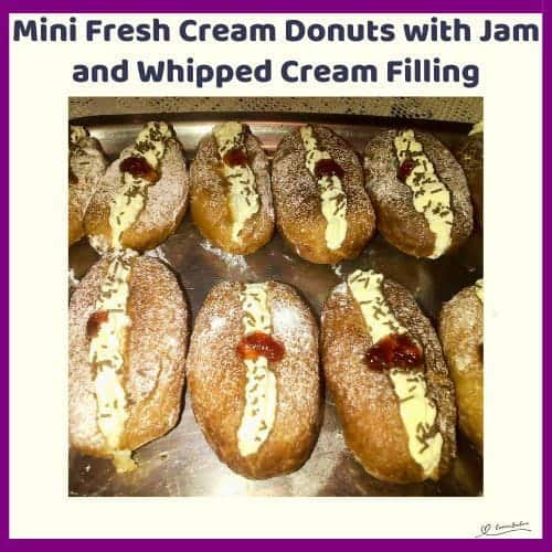 An image of Mini Fresh Cream Donuts with Jam and Whipped Cream Filling and a dollop of jam