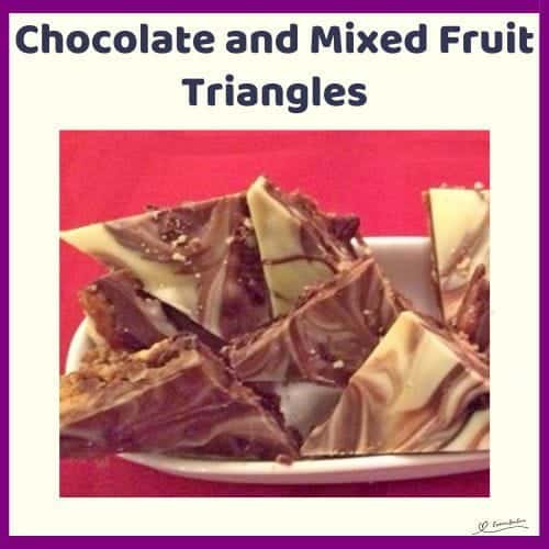 An image of Chocolate and Mixed Fruit Triangles with biscuit pieces and studded with dried fruit