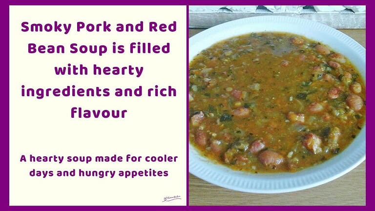 An image of a white bowl of Smoky Pork and Red Bean Soup with loads of vegetables and pork rashers