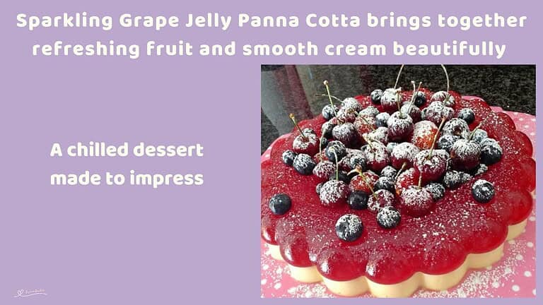 An image of a Sparkling Grape Jelly Panna Cotta, decorated with frosted cherries and fresh berries and a dusting of icing sugar
