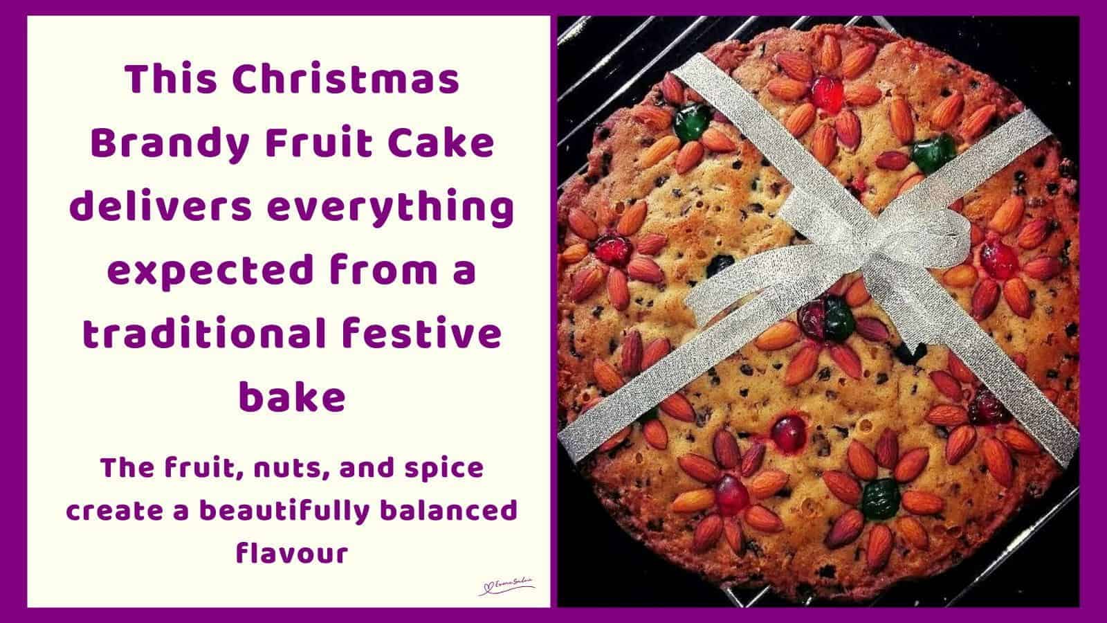 An image of a Christmas Brandy Fruit Cake Decorated with Nuts, Cherries and a Ribbon