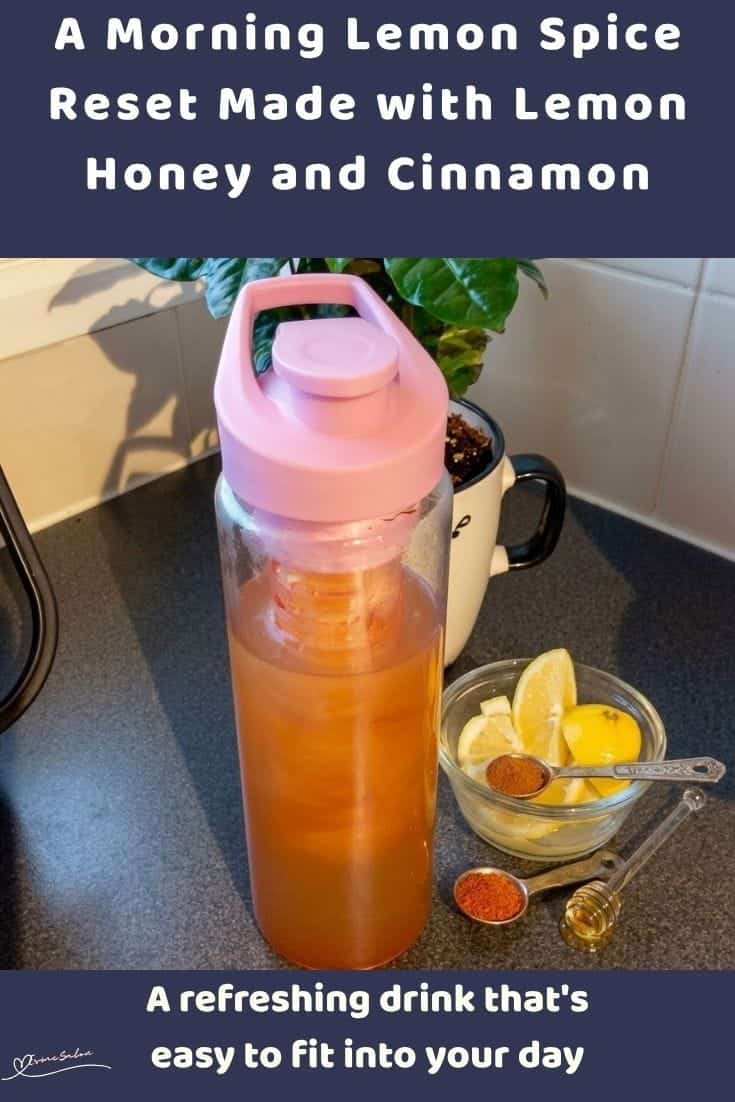 An image of a travel mug with Morning Lemon Spice Reset made with fresh lemon, honey, cinnamon, and cayenne pepper