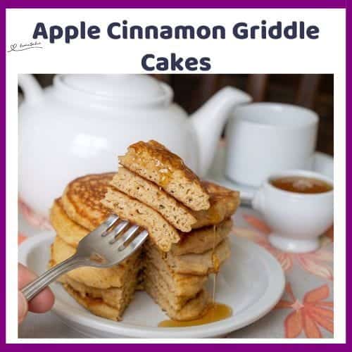 An image of a stack of Apple Cinnamon Griddle Cakes with Granny Smith apple, cinnamon powder and syrup next to a tea pot and a tea cup