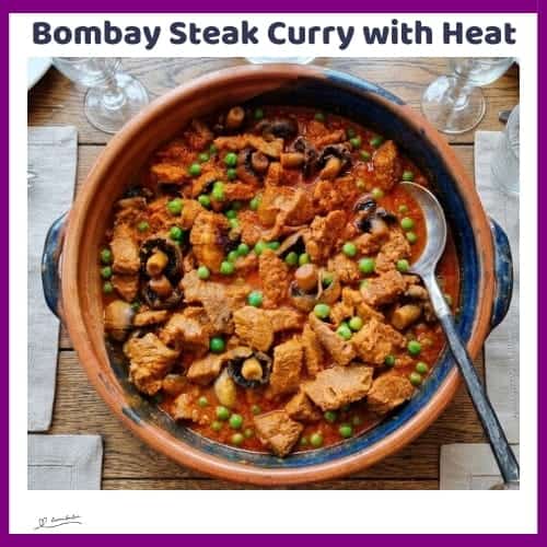 An image of a plate of Bombay Steak Curry with mushrooms and bold curry spices