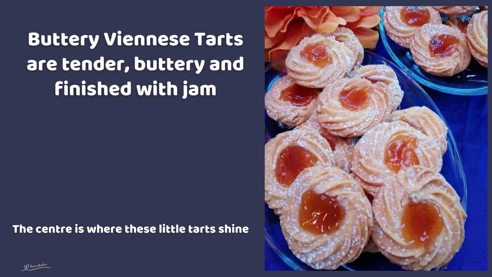 An image of Buttery Viennese Tarts, with jam centers and a dusting of icing sugar