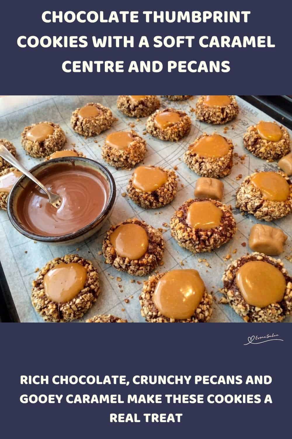 An image of a tray filled with Chocolate Thumbprint Cookies coated with pecan nuts and a caramel centre