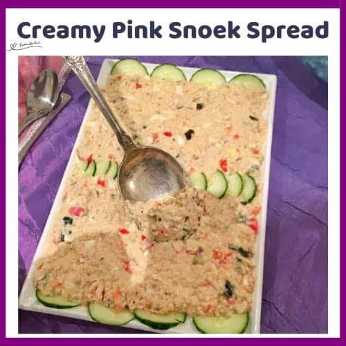 An image of a platter with a Pink Creamy Snoek Spread with dill cucumbers, finely chopped hard-boiled egg and chopped tomato