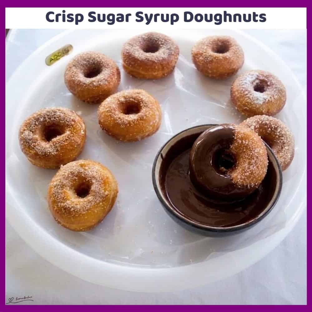 Delicious sugar syrup doughnuts with chocolate dip on a white plate.
