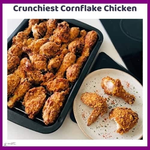 An image of a dripping rack with Crunchiest Cornflake Chicken made of cornflakes, spices and buttermilk