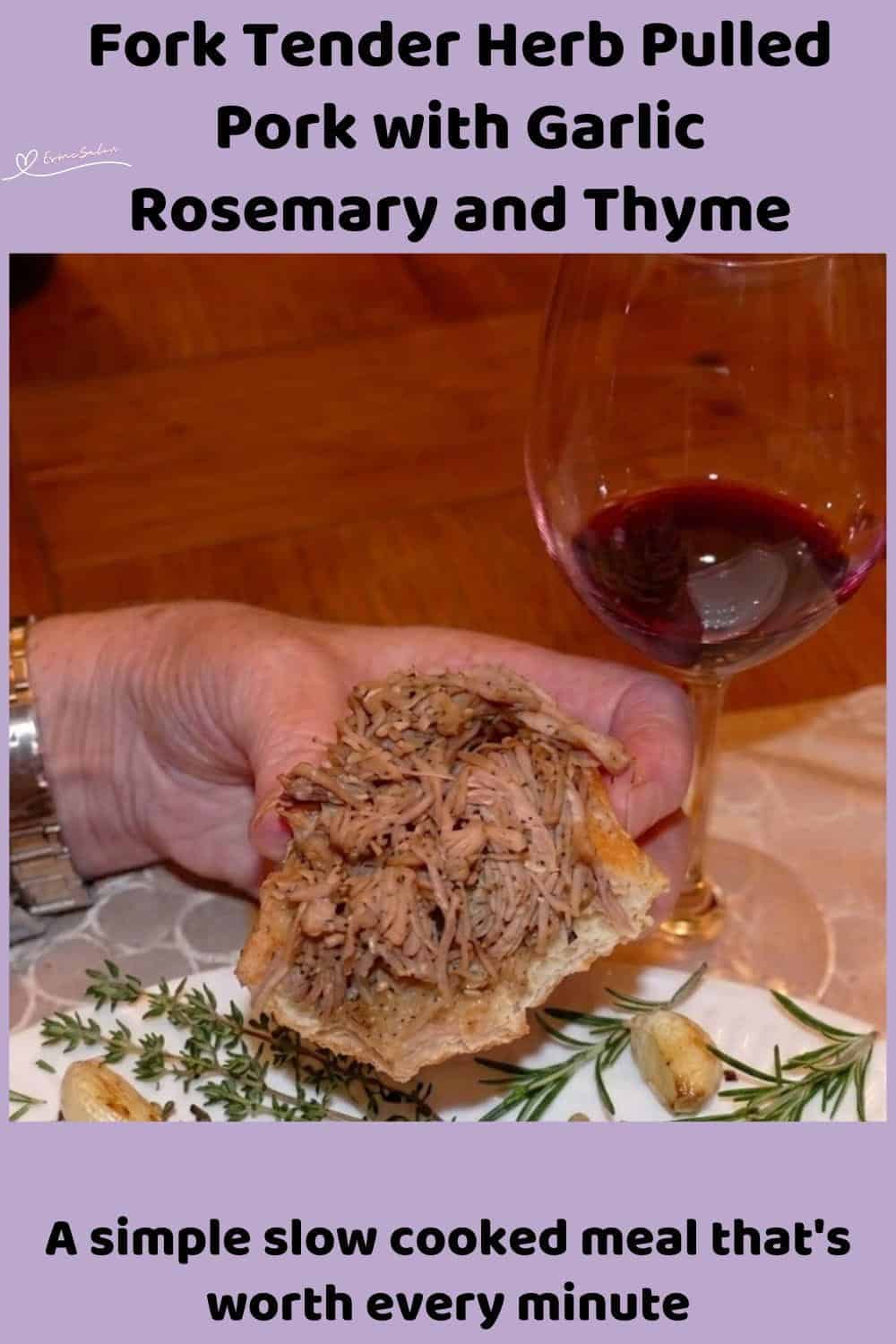 An image of slow-cooked Herb Pulled Pork on a bread roll with a glass of red wine in the background