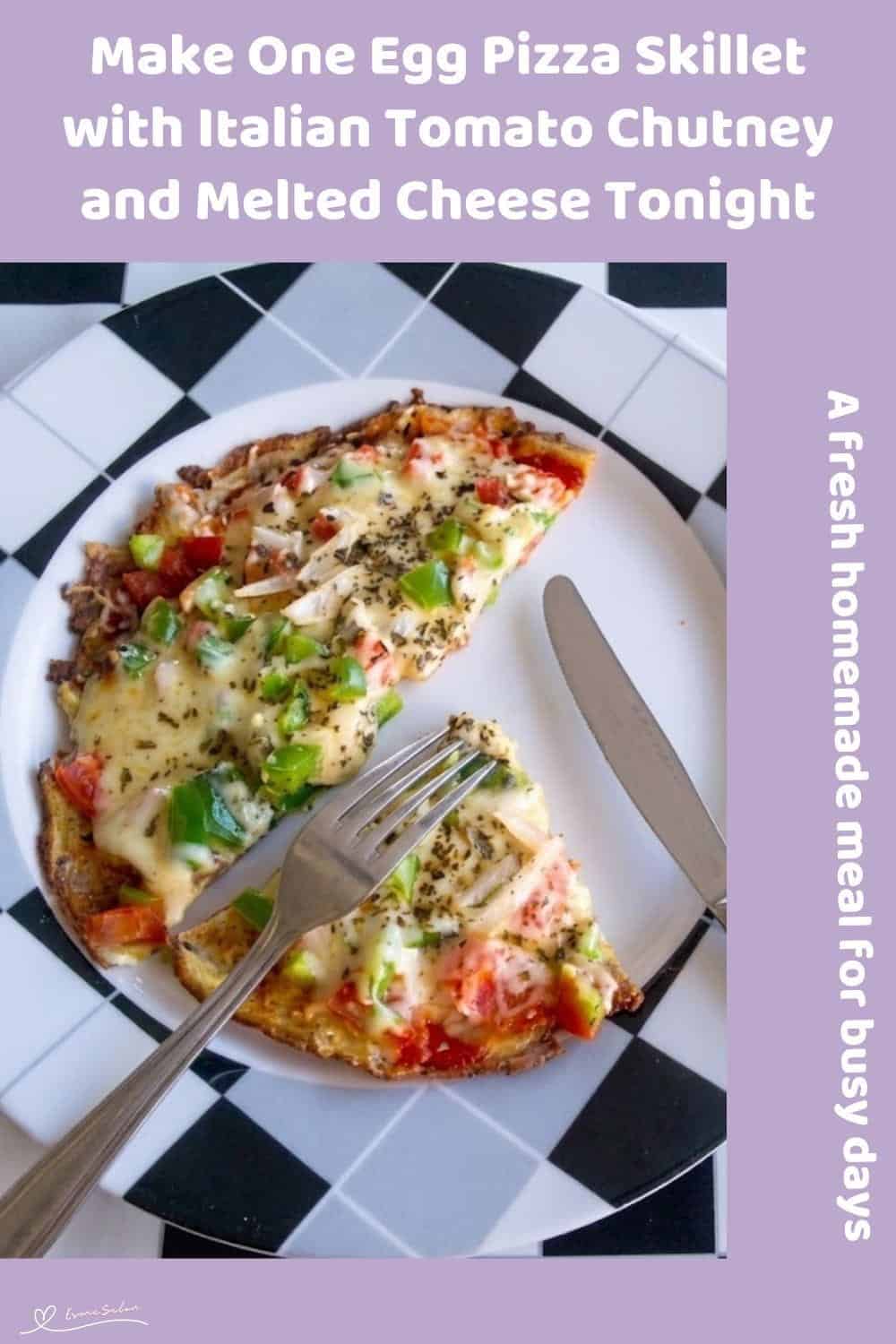 Delicious homemade egg pizza with cheese, tomatoes, and green peppers on a checkered plate.