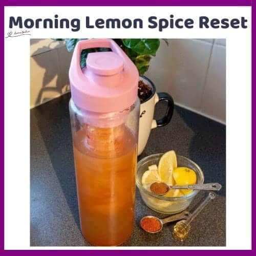 An image of a travel mug with Morning Lemon Spice Reset made with fresh lemon, honey, cinnamon, and cayenne pepper