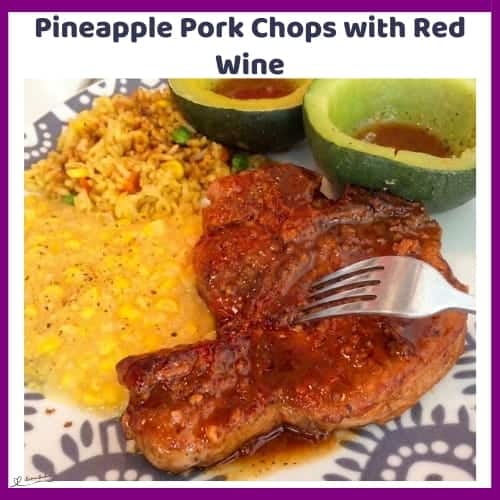 An image of a plate with Pineapple Pork Chops with Red Wine, served with rice, squash and sweetcorn