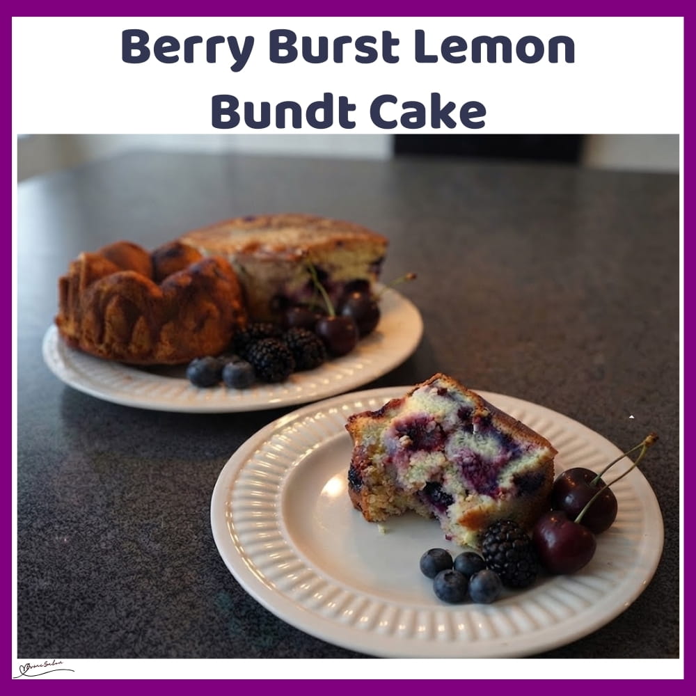 An image of a Lemon Bundt Cake with blueberries, blackberries and dark sweet cherries