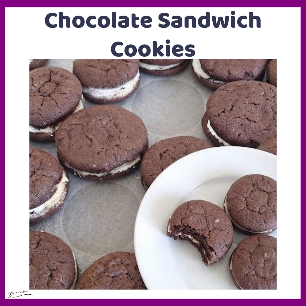 An image of a white plate with Chocolate Sandwich Cookies with white icing filling