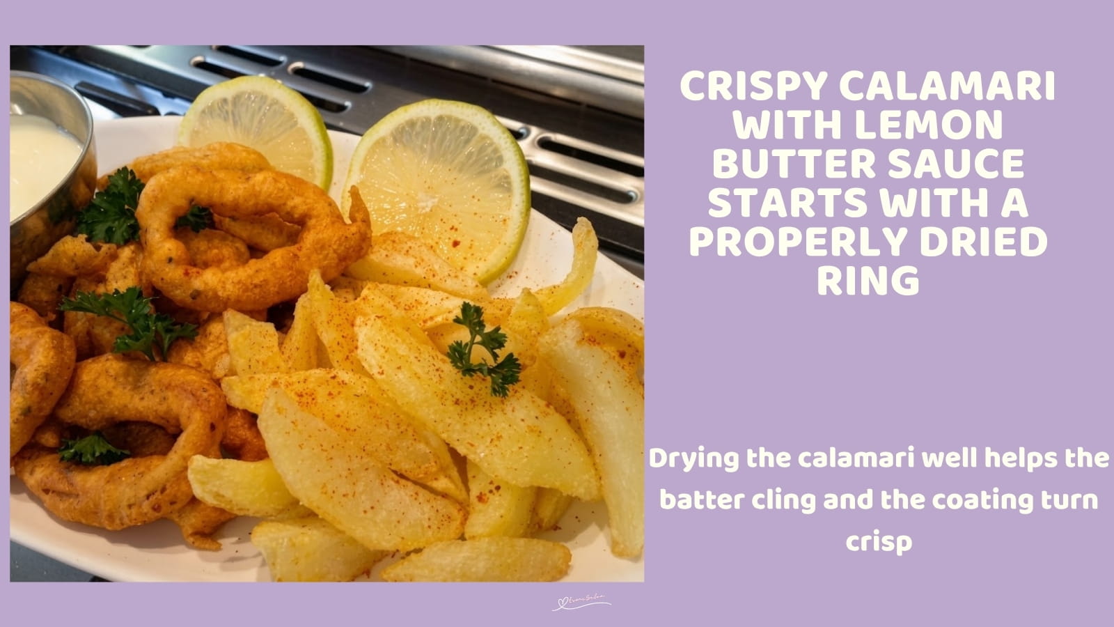 An image of a plate of Crispy Calamari with Lemon Butter Sauce, fries and slices of lemon