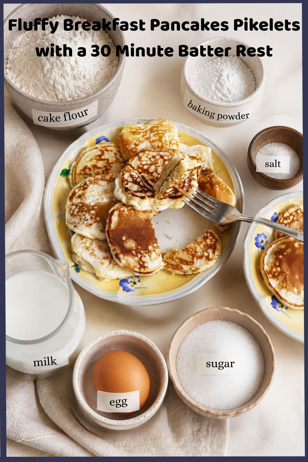 An image of a stack of Fluffy Breakfast Pancakes Pikelets with a bottle of syrup on the side