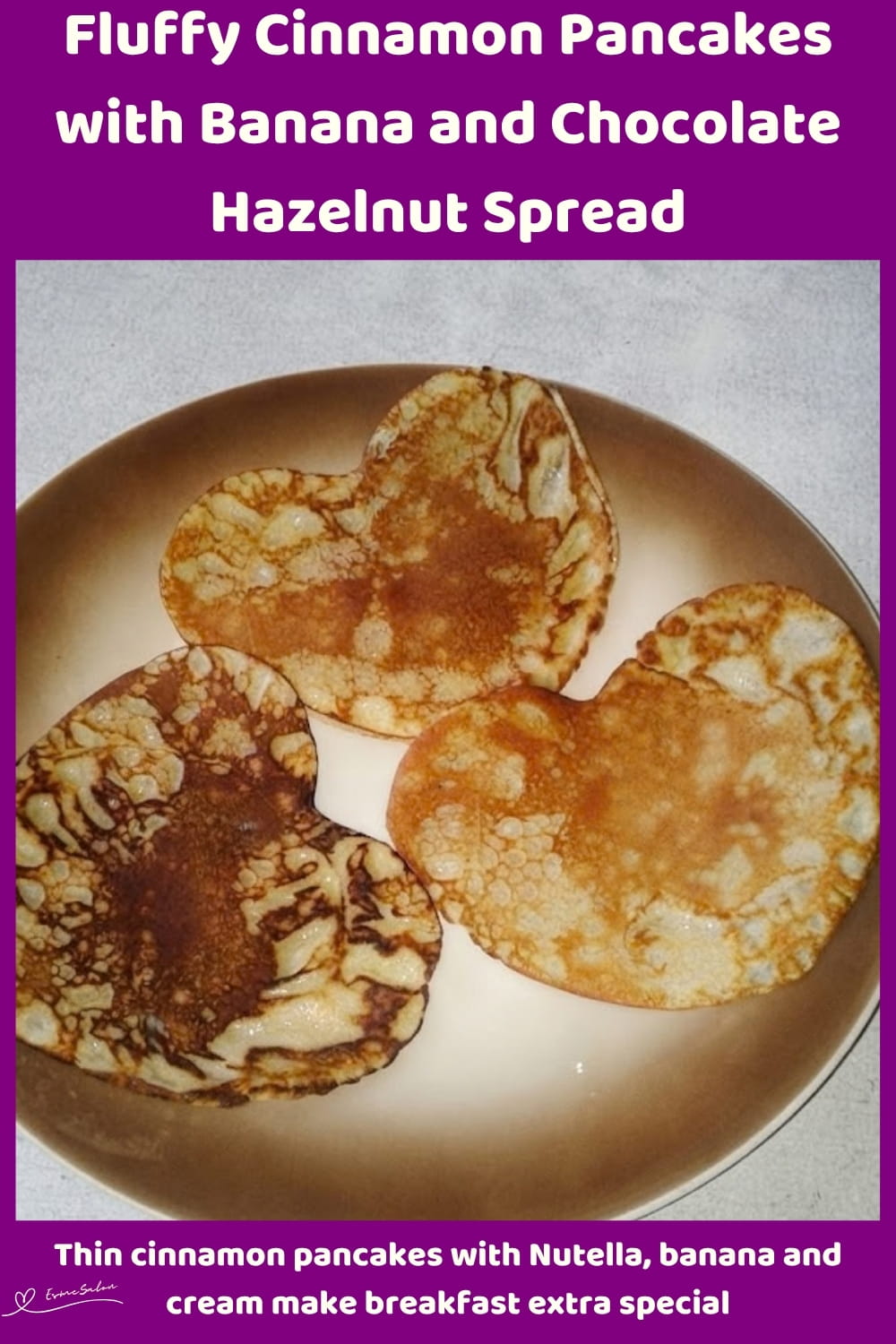 An image of heart-shaped cinnamon pancakes with Nutella and sliced bananas
