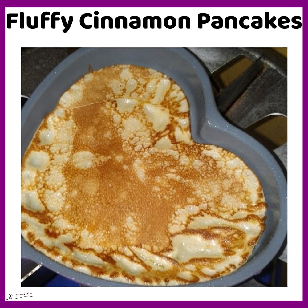 An image of heart-shaped cinnamon pancakes with Nutella and sliced bananas