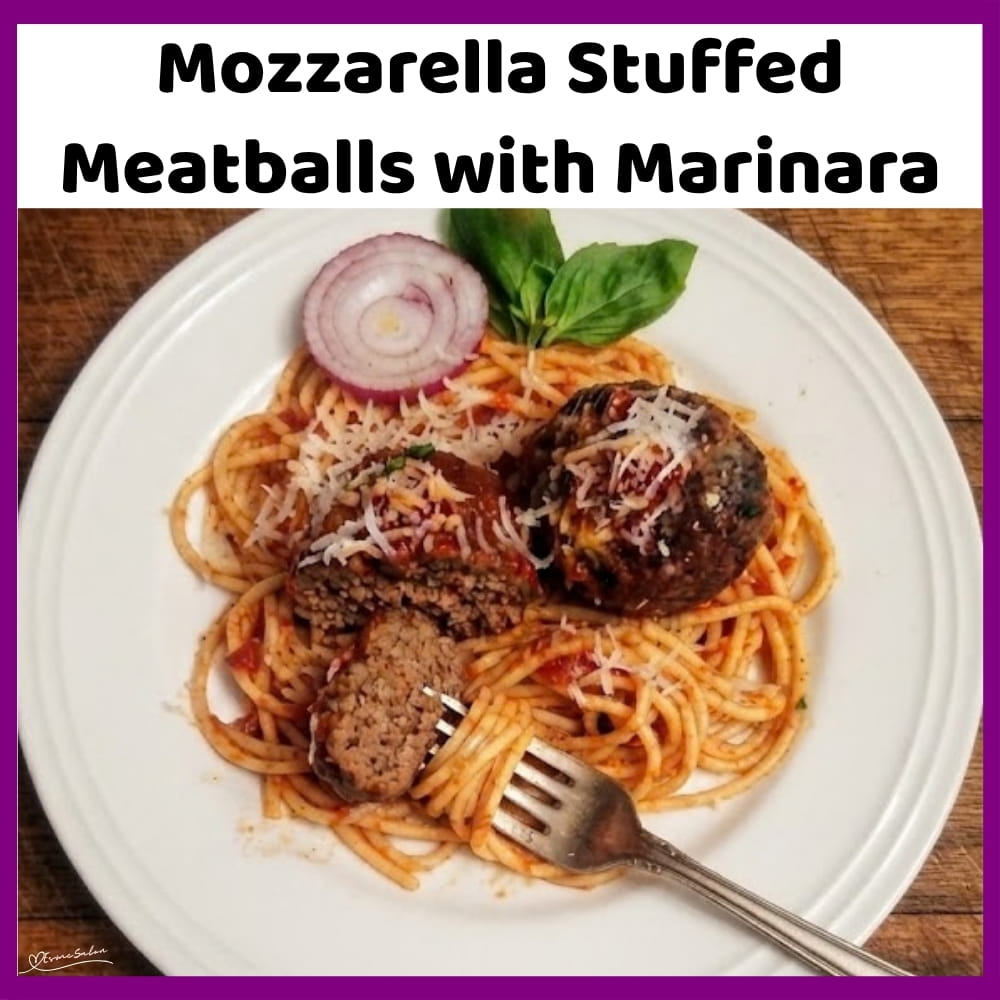 An image of a plate with Meatballs with Marinara and stuffed with Mozzarella
