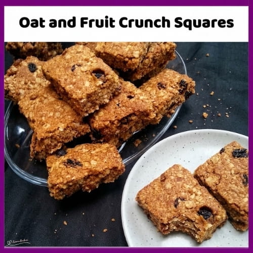 An image of a dish of Oat and Fruit Crunch Squares made of rolled oats, currants, coconut and golden syrup