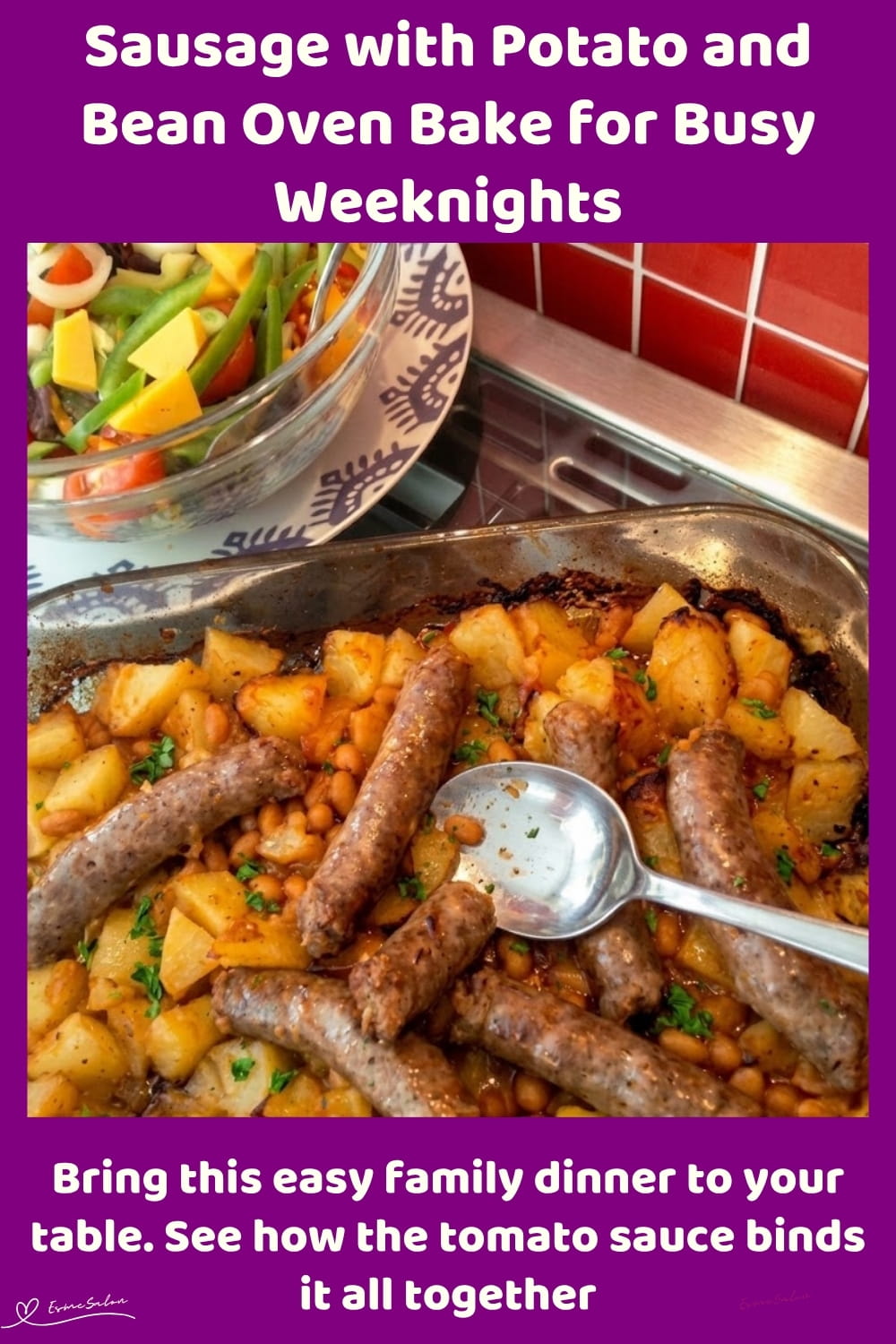 An image of a plate with oven-baked sausage, Potato, baked beans and a side of salad