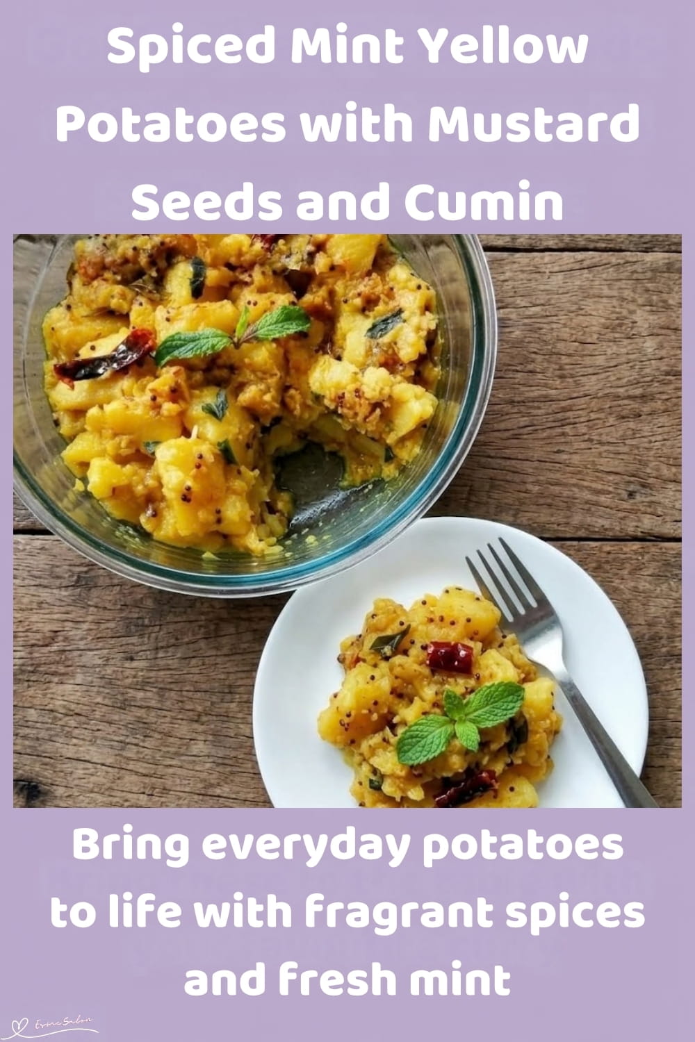 An image of a plate of yellow potatoes with cumin, turmeric and fresh mint