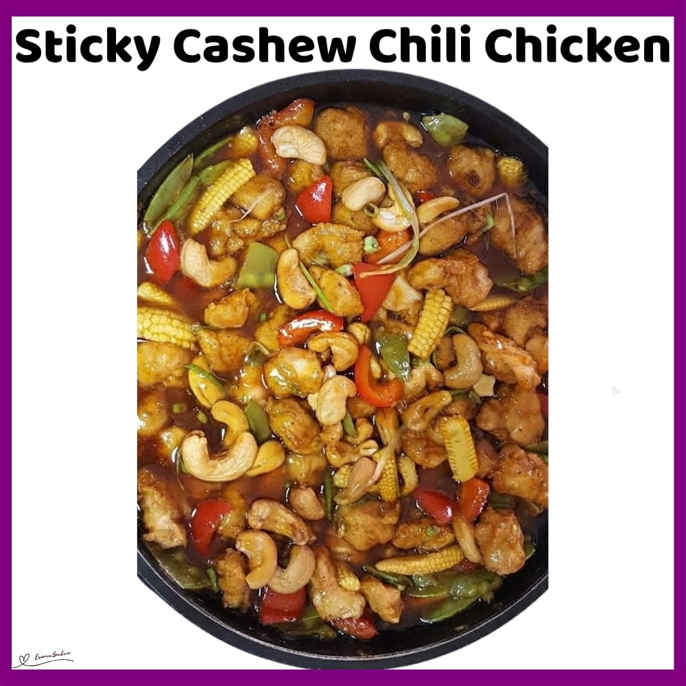 An image of a skillet with Sticky Cashew Chili Chicken Cubes with red peppers, cashew nuts, and Baby corn