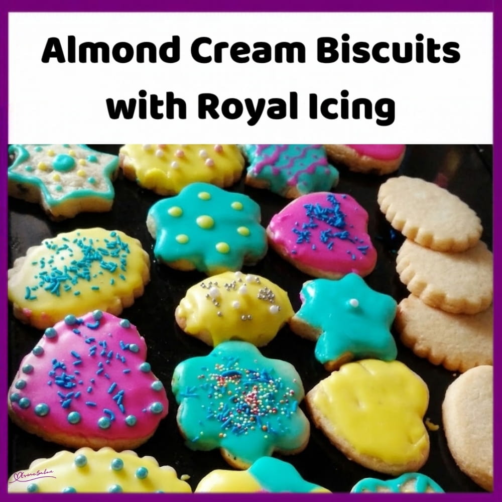 An image of a plate of decorated almond-cut-out buttery biscuits with royal icing, creatively decorated