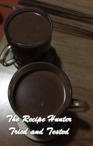 Two brown mugs filled with Dark Hot Chocolate