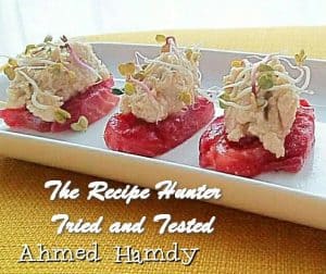 Homemade Cured Salmon in a white platter with hummus