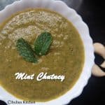 Mint Chutney in a white dish with two mint leaves in the center