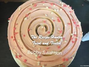 Easy Red Velvet Cake with cream cheese frosting and decorated with white and red hearts