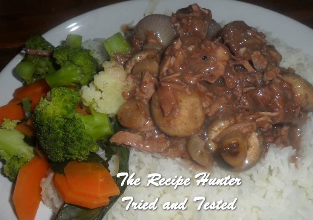 Beef Bourguignon served with broccoli and carrots on rice