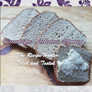 Slices of Low Carb Sunflower Yeast Bread with butter spread on the front one