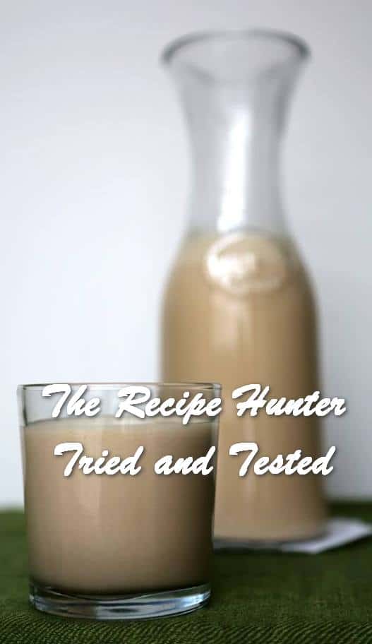 a bottle and glass filled with Homemade Irish Cream.