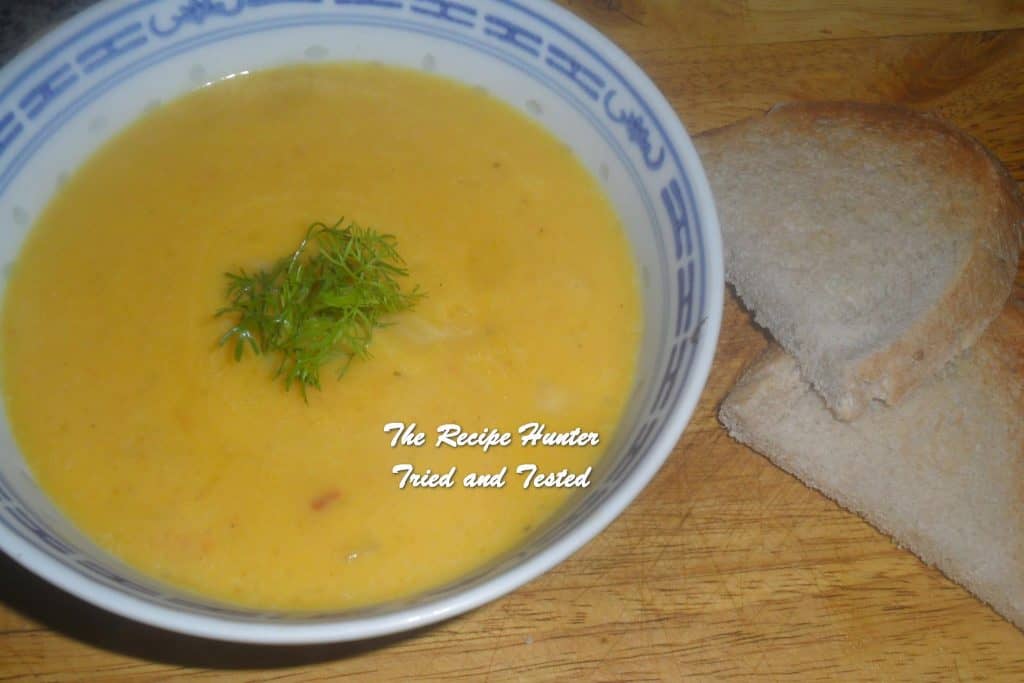 a bowl of Homemade Squash Soup with some green in the center
