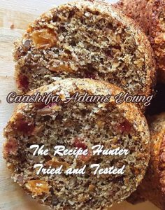 Healthy Mixed Berry And Seed Muffins cut open with lots of fruit